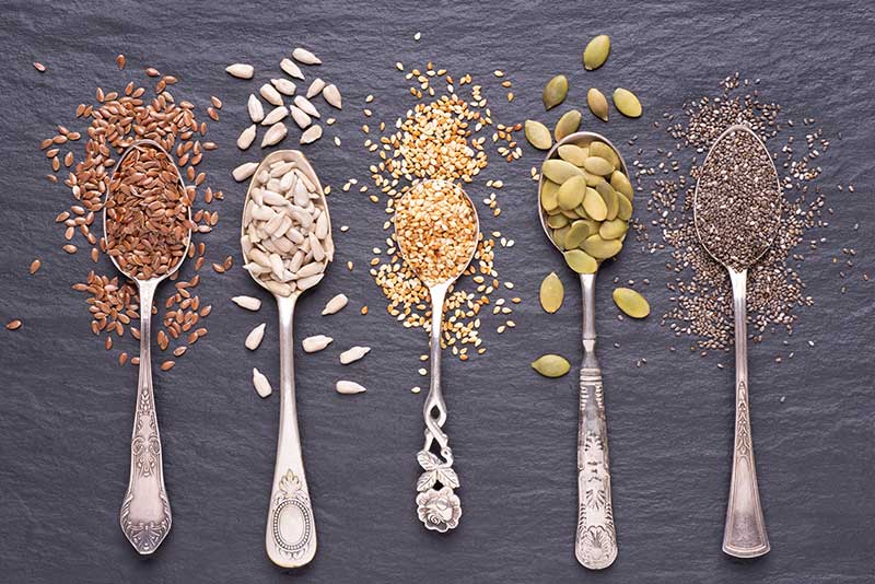 A variety of healthy seeds, including chia, flax, sunflower, and pumpkin, for nutrition.