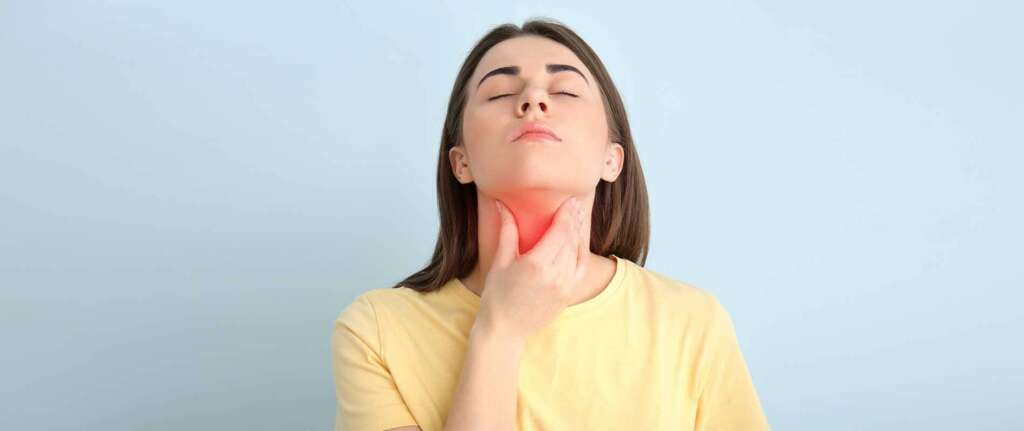 Person practicing pranayama breathing exercises for thyroid health in a serene, natural setting.